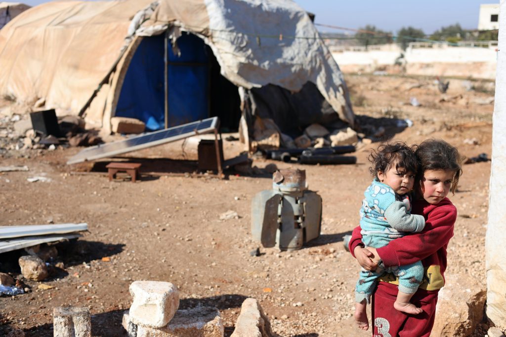 pexels-photo-30390247-30390247 A touching scene of children in a refugee camp in Idlib, Syria, highlighting resilience.